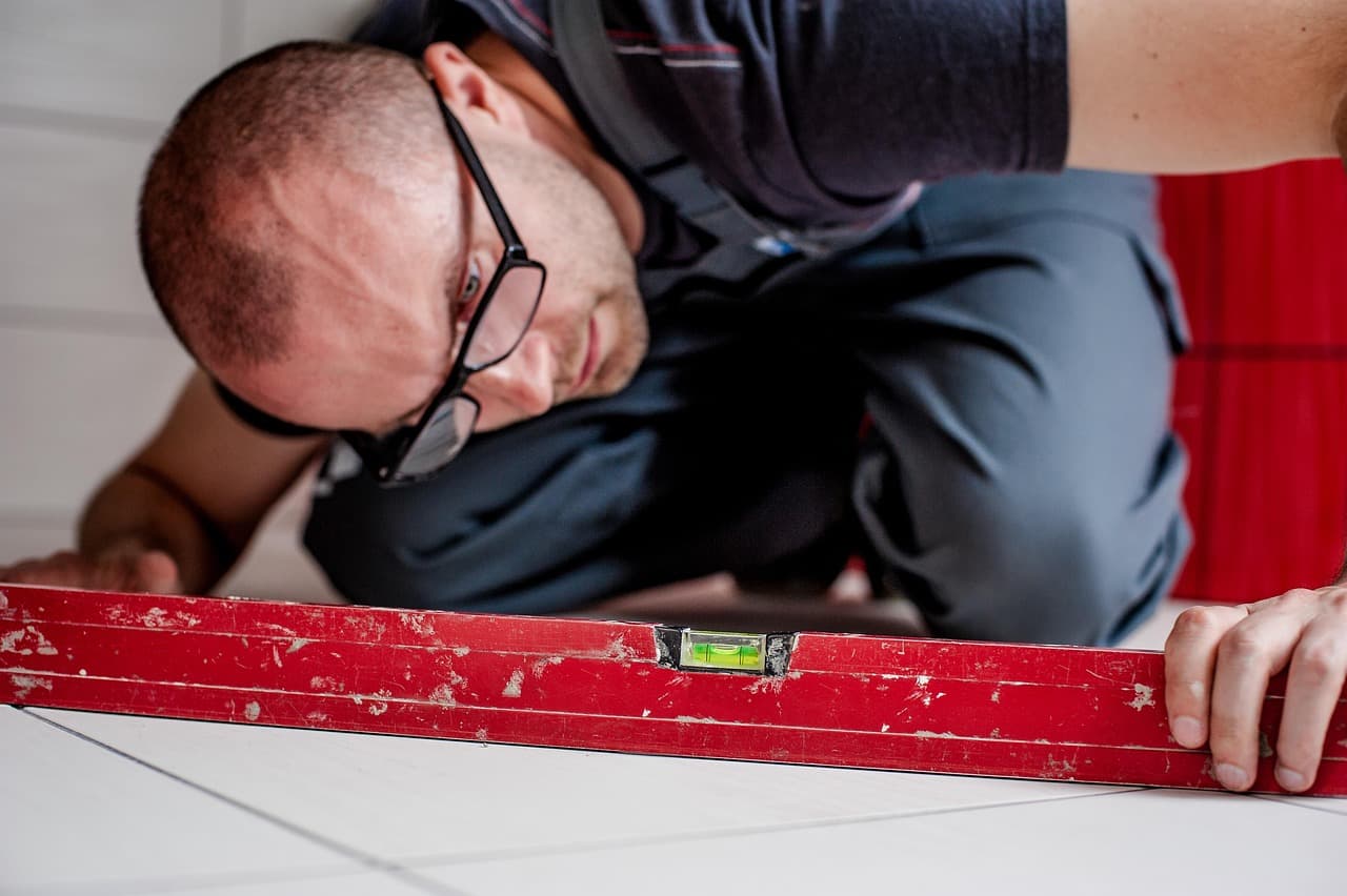 Checking a level on a floor during a fitting job