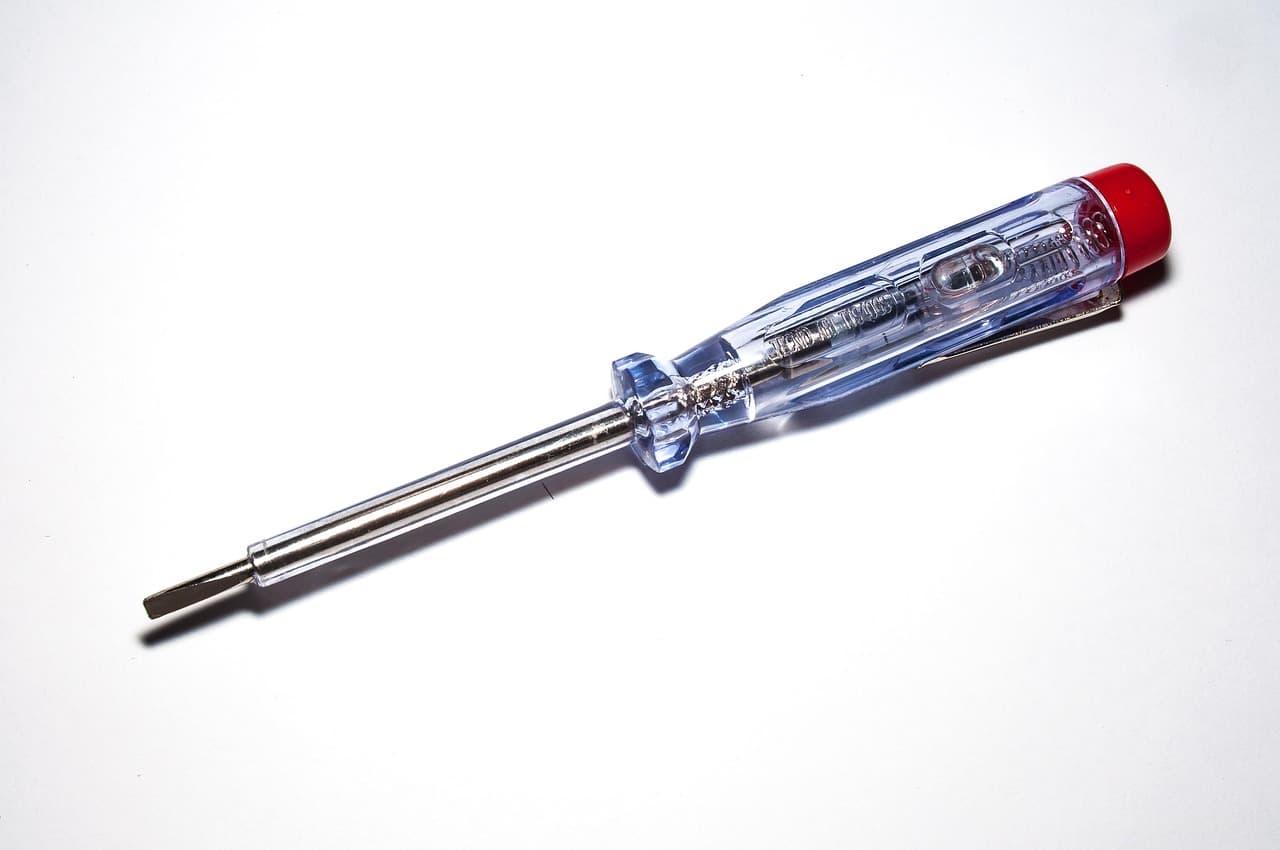 A screwdriver mains tester on a white background